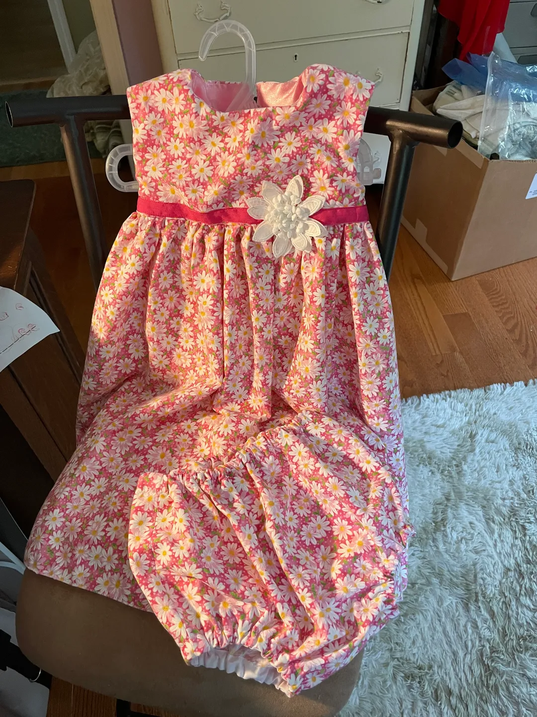 Pink and white floral dress with matching bloomers for a baby girl.